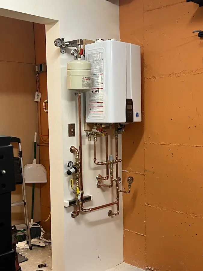 Plumbing technician inspecting water heater connections in South Lebanon